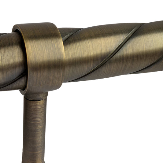 Close-up of a brass curtain rod with a white background
